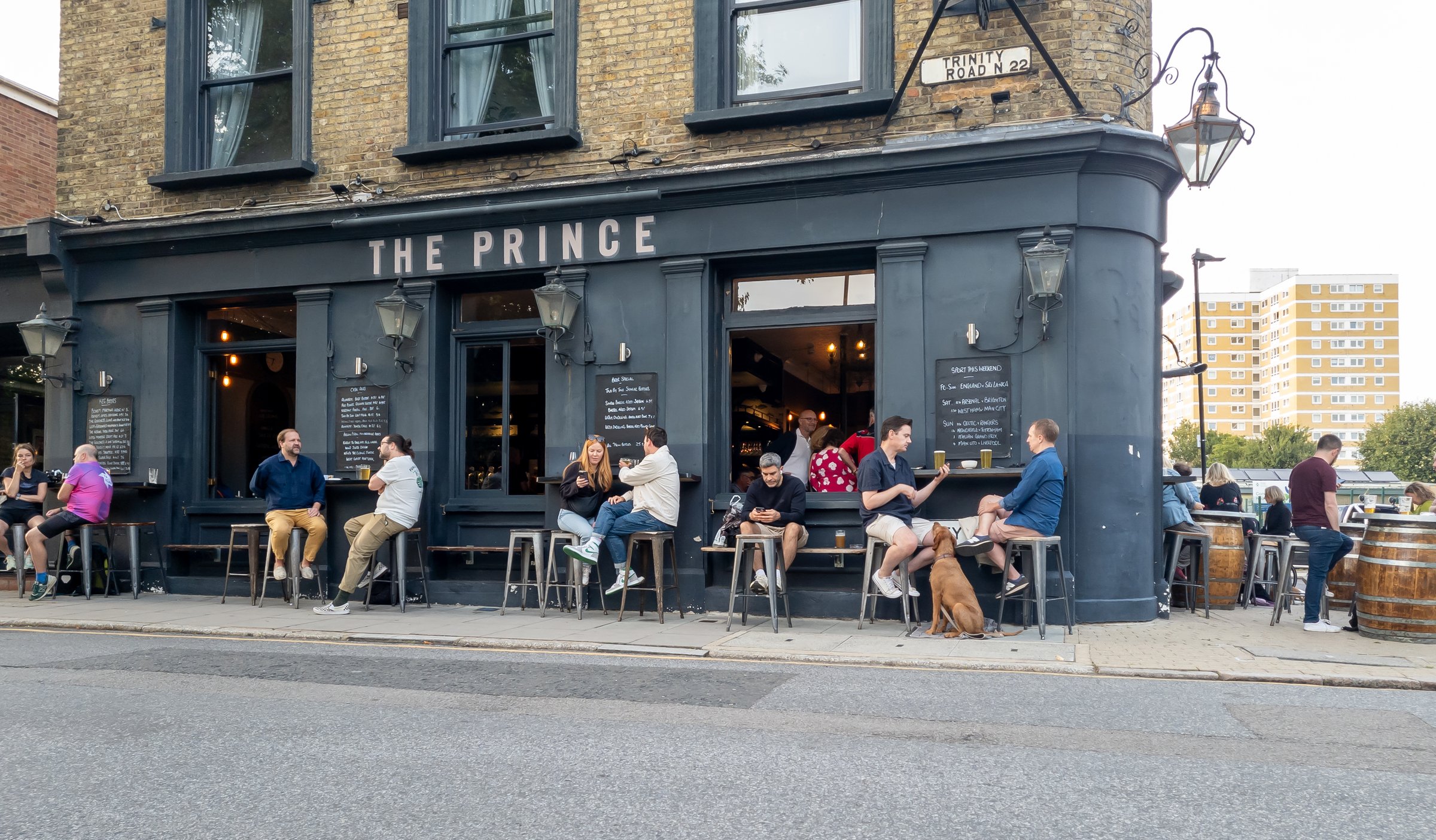 London. UK- 08.30.2024. People living the British pub culture, enjoying a drink and socialising outside a pub on a warm sunny Summer day.