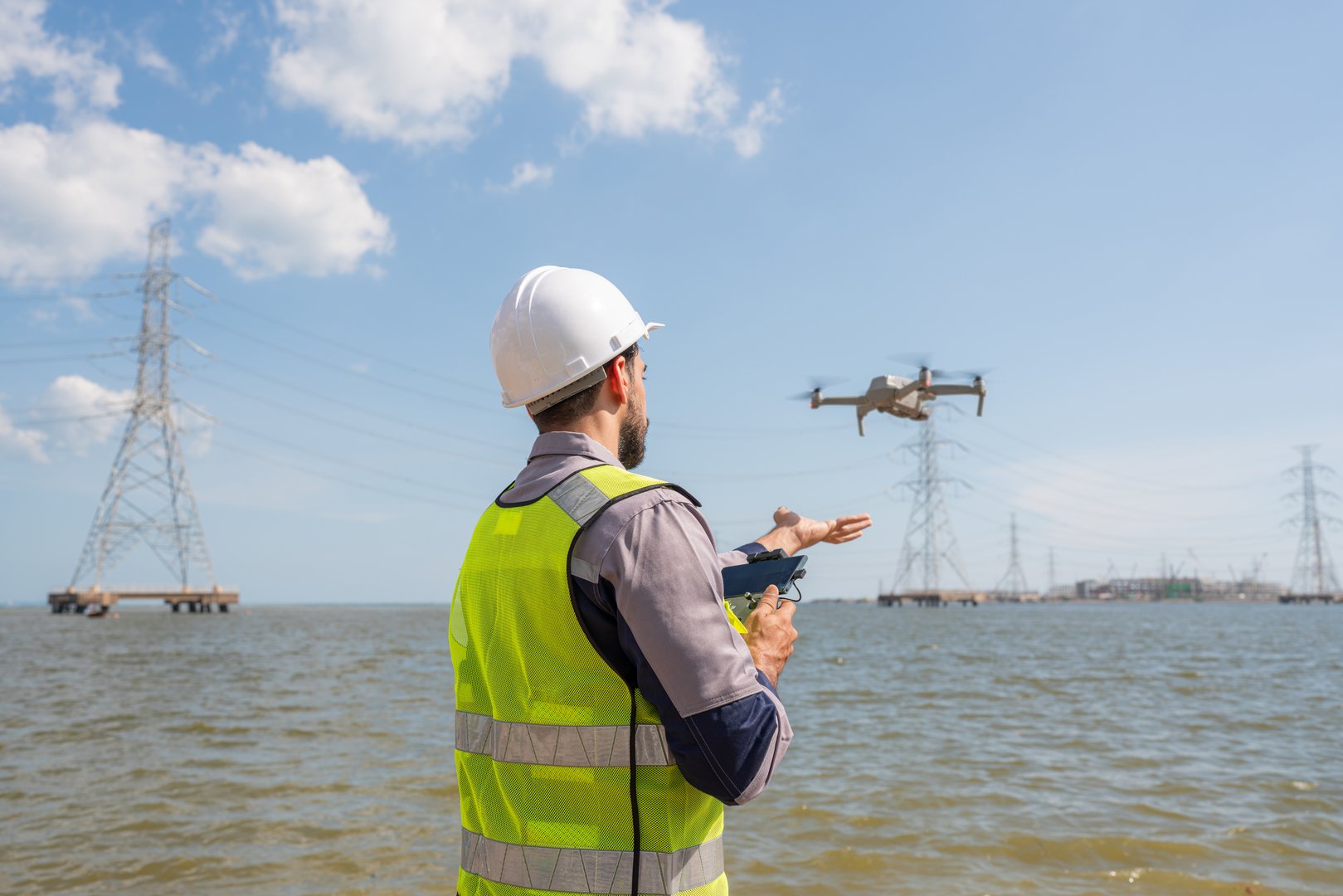 Engineer Specialists Pilot Drone on Construction Site. Architectural Engineer and Safety Engineering Inspector Fly Drone at industrial plant.