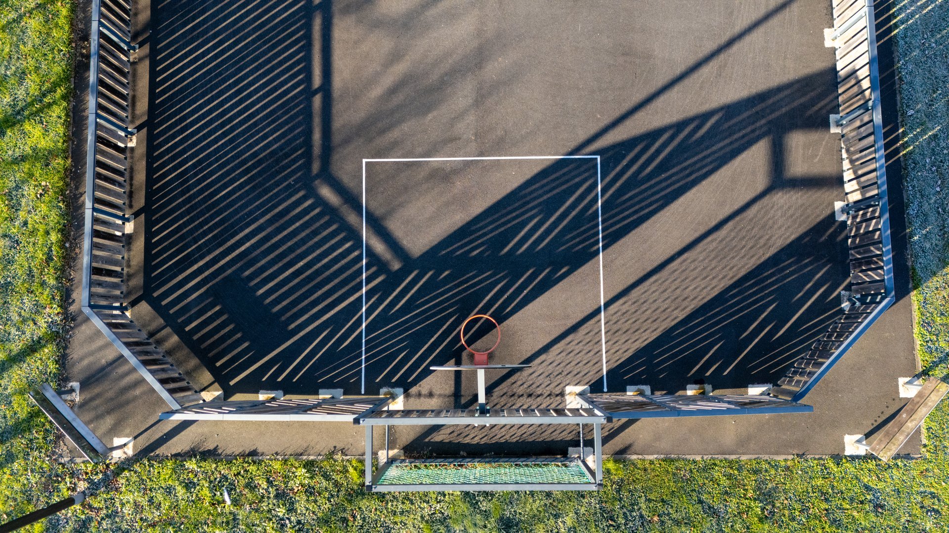 Empty Basketball Court with Striking Shadows