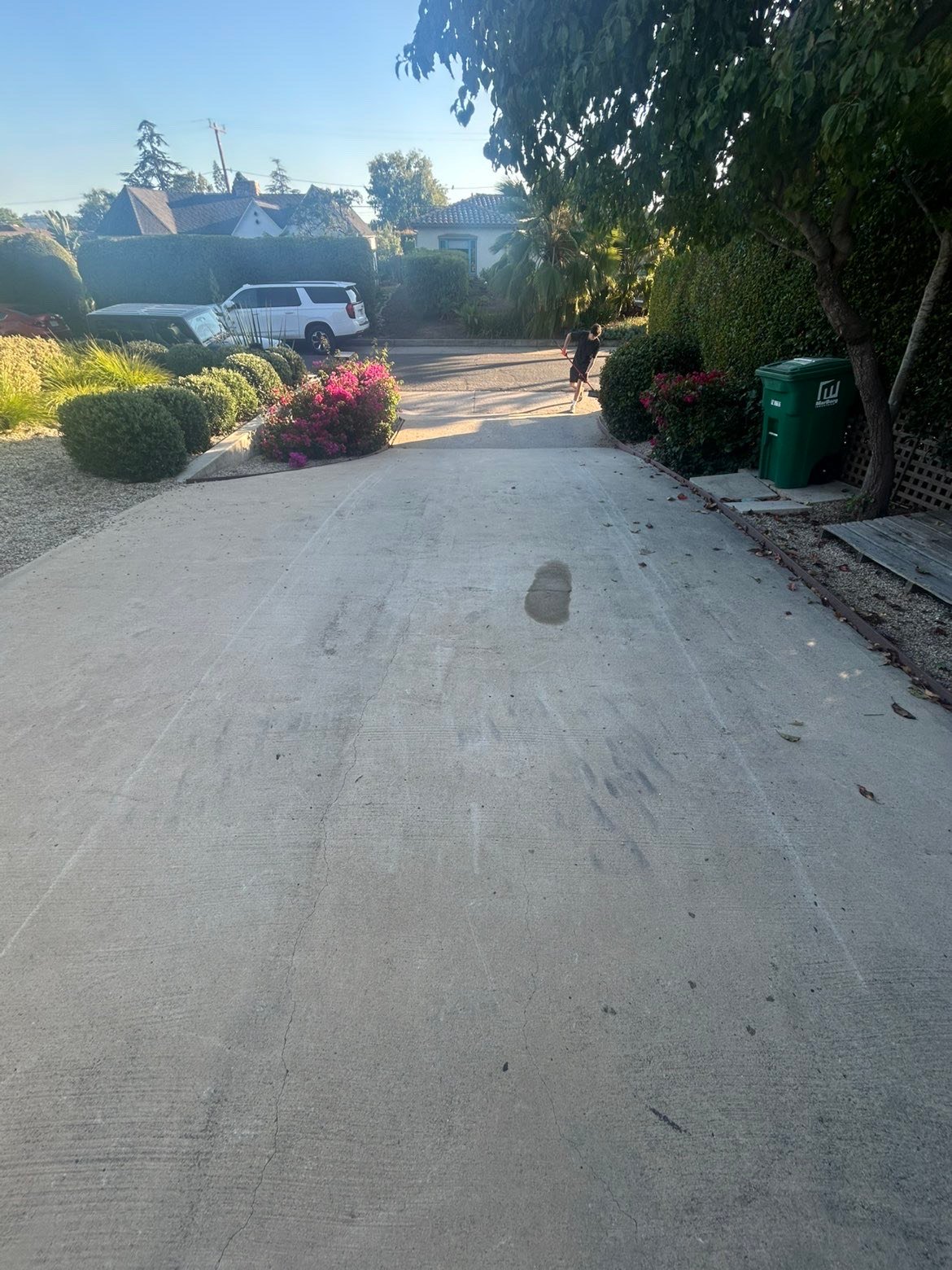 Dirty driveway before pressure washing showing significant staining and buildup