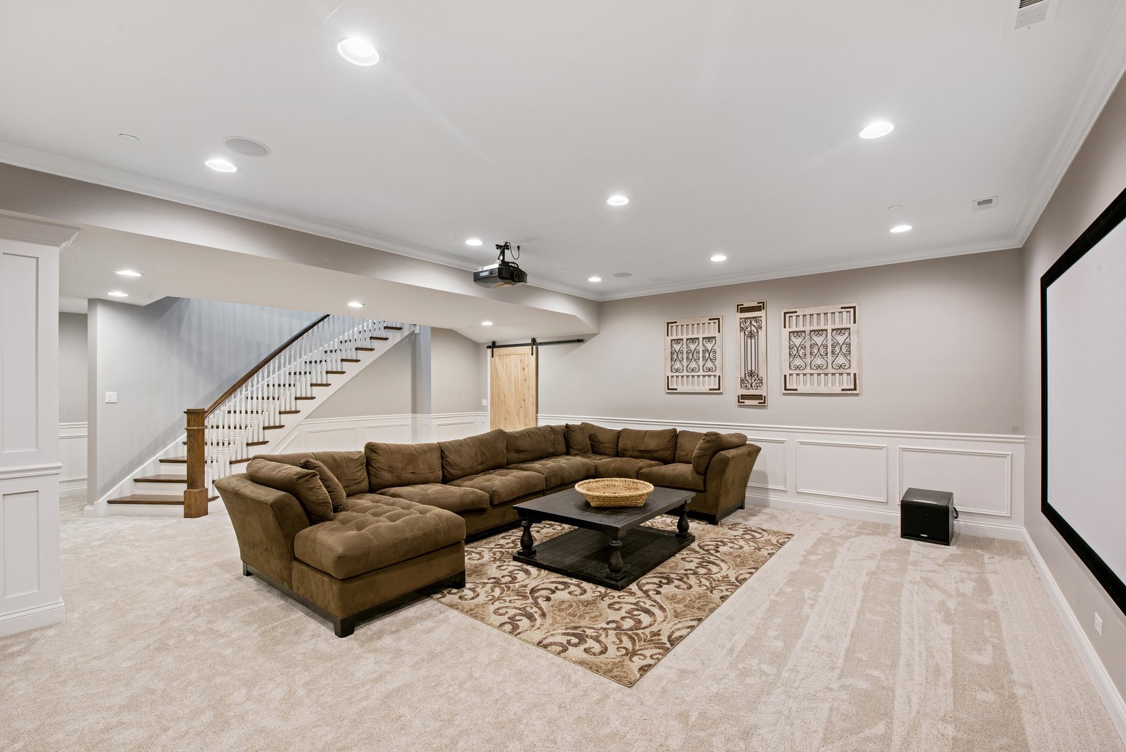 Light carpet and big sectional sofa in basement room
