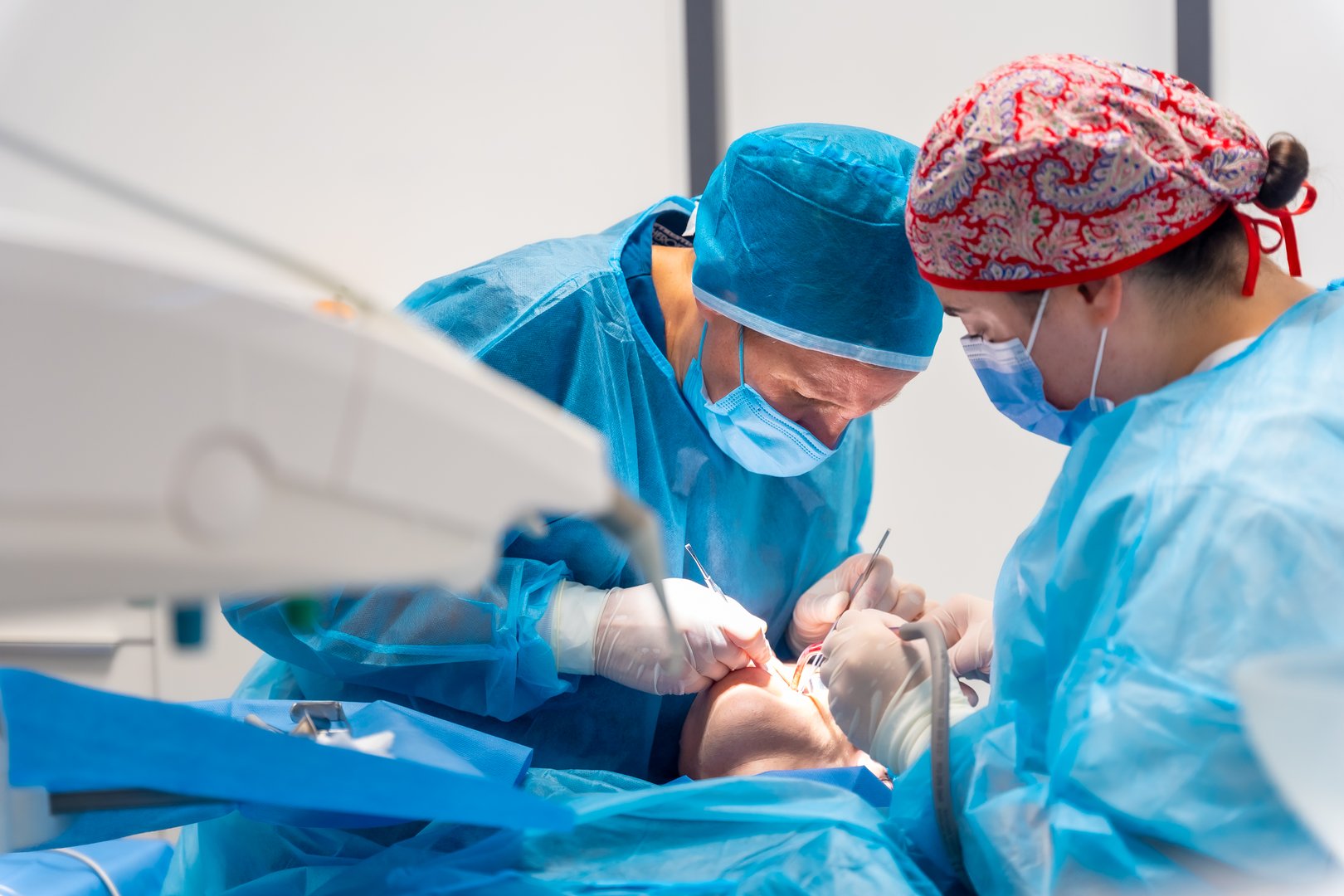 Dentists performing oral operation