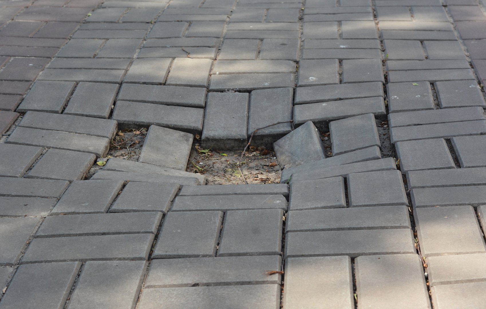 Hole on paving blocks road.  Problem with bad pavement.