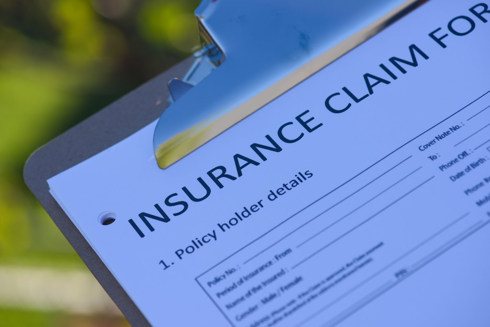 insurance claim form on clipboard