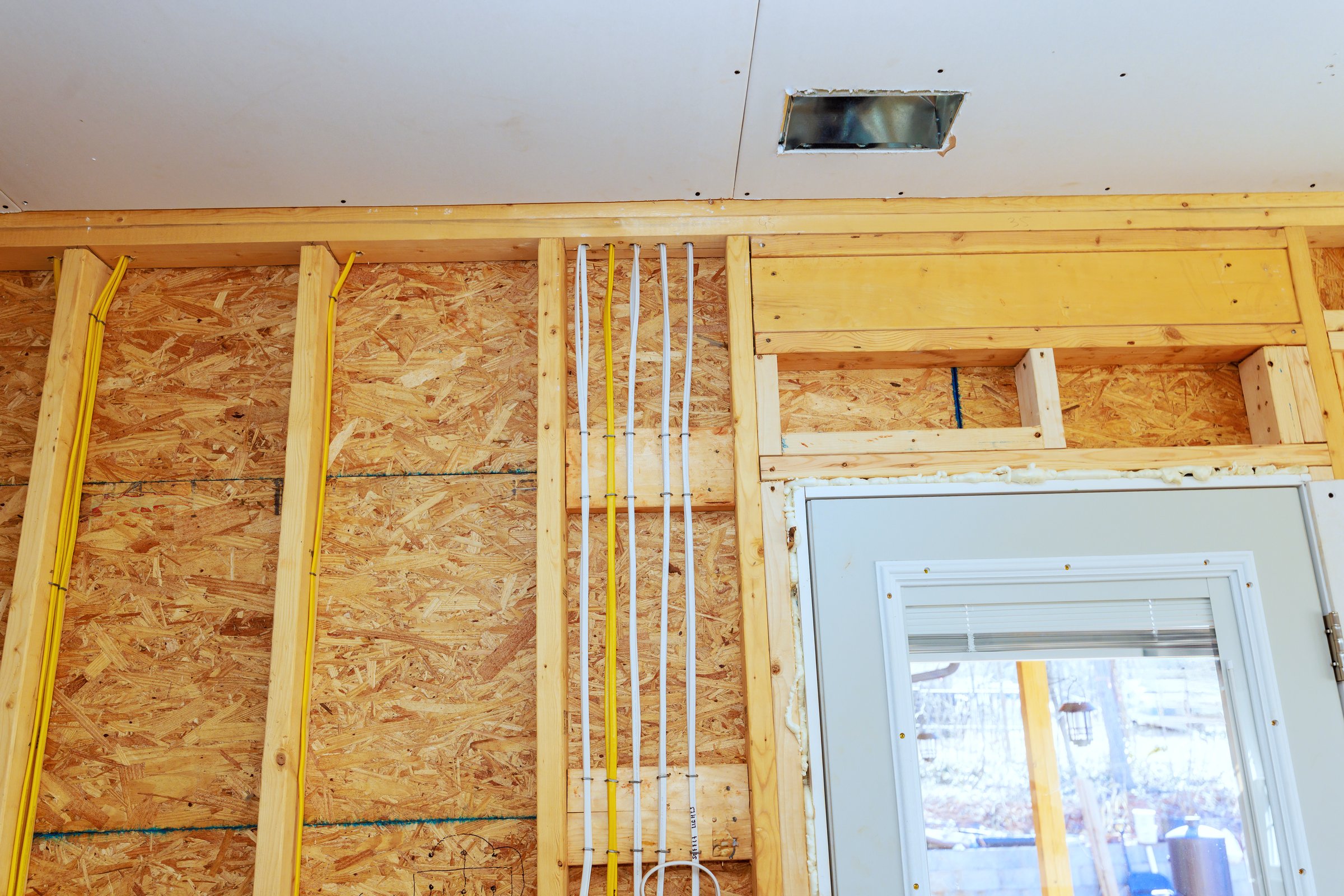 Installing wood framing, electrical wiring in residential construction project during installing drywall
