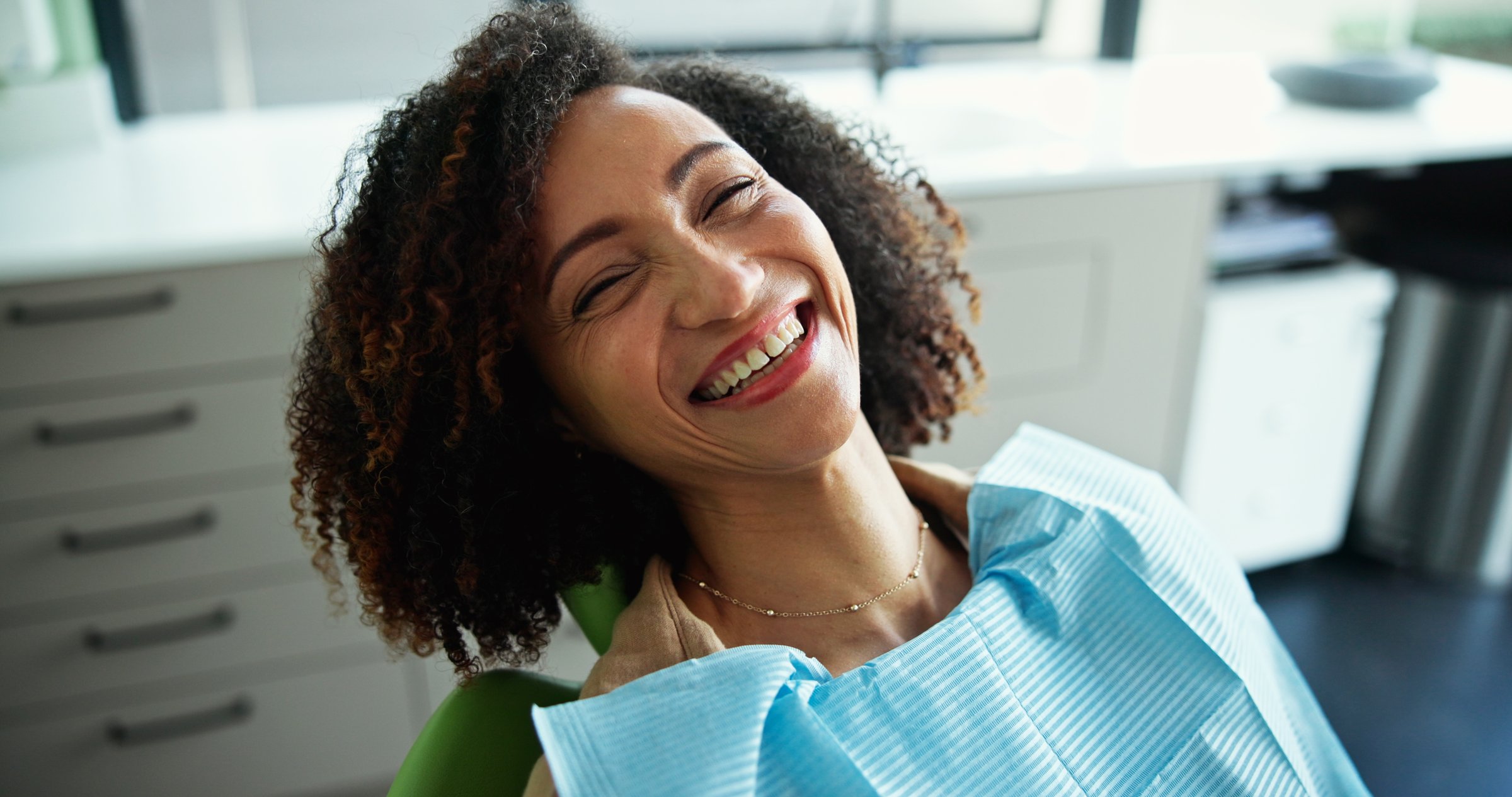 Dentist, smile and portrait of woman in clinic for consulting, teeth whitening and wellness. Healthcare, dentistry and patient with hygienist for dental hygiene, oral care and medical services