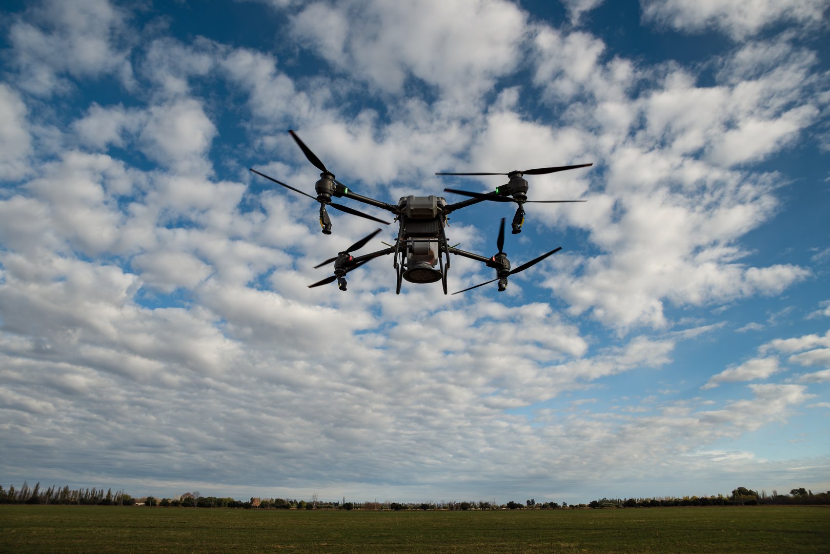San Rafael, Argentina, May 25, 2025: Agricultural drone spreading fertilizer on a newly planted field in Argentina. Smart farm. Unmanned aerial vehicle (UAV).