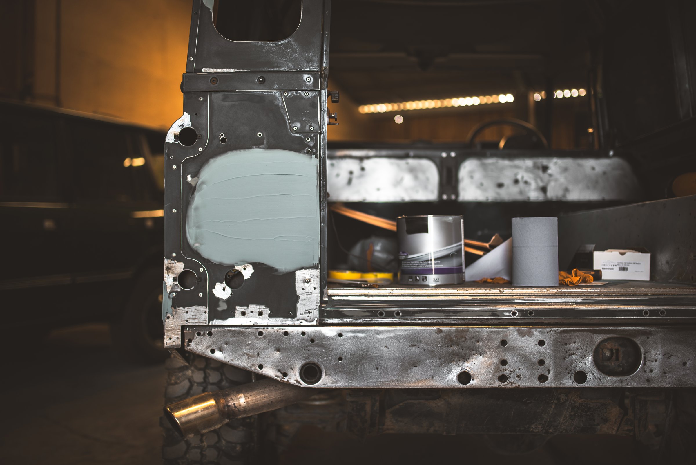 A detailed shot of a off road vehicle undergoing restoration, showcasing the bodywork and repair process