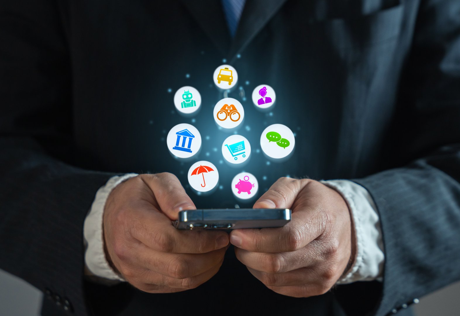 Businessman with a phone and a cloud of various services and mobile applications
