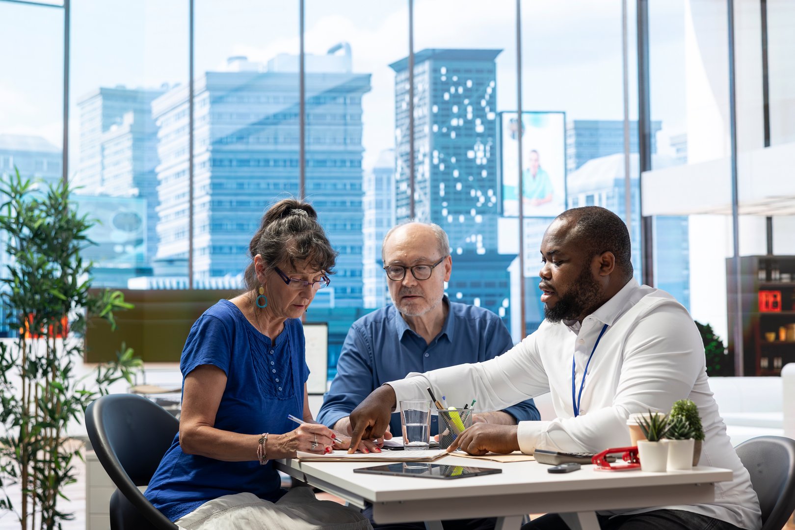 Senior woman signing the pension plan contract to develop a suitable retirement plan with financial broker, focusing on life savings, investments and securing financial future.