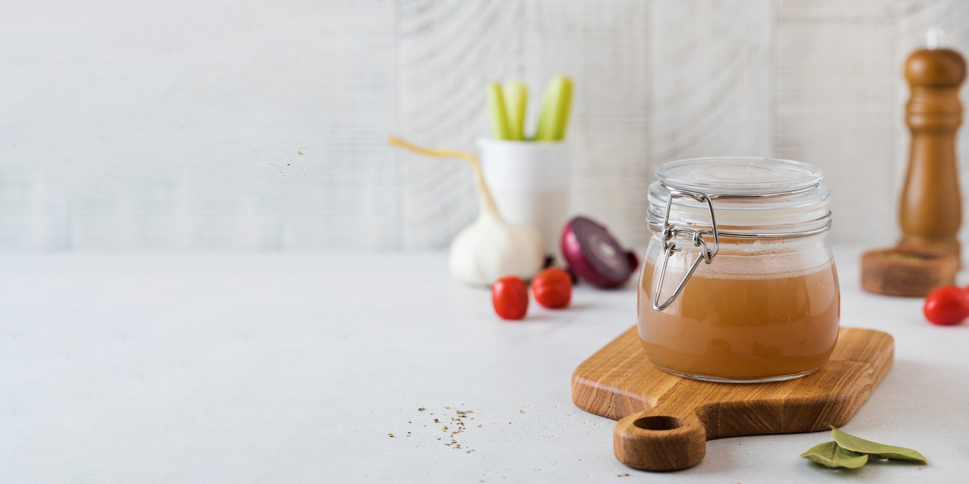 Bone broth soup in glass jar for storage on a wooden board. The concept of healthy eating. High quality photo
