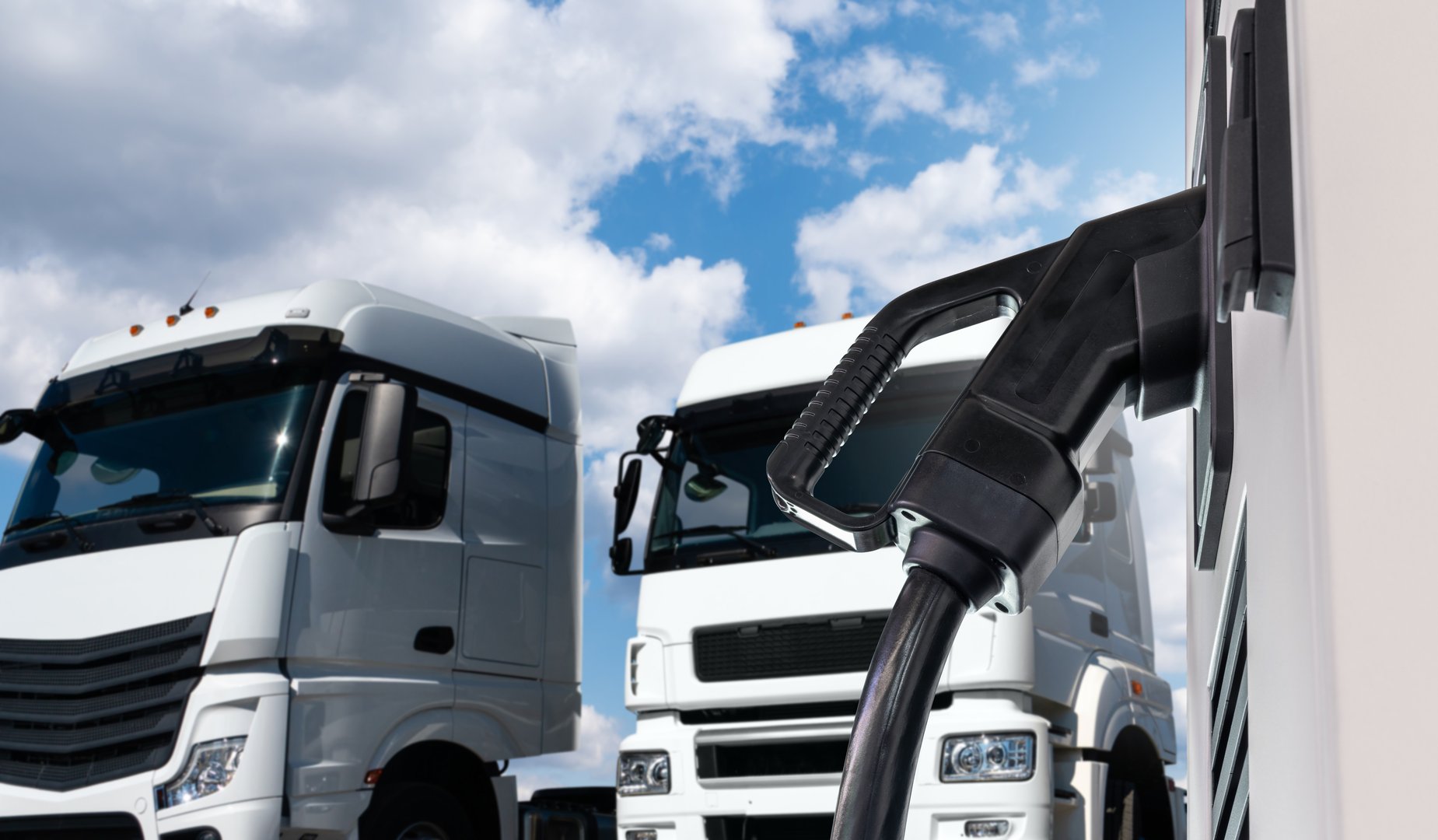 Electric vehicles charging station on a background of a trucks.