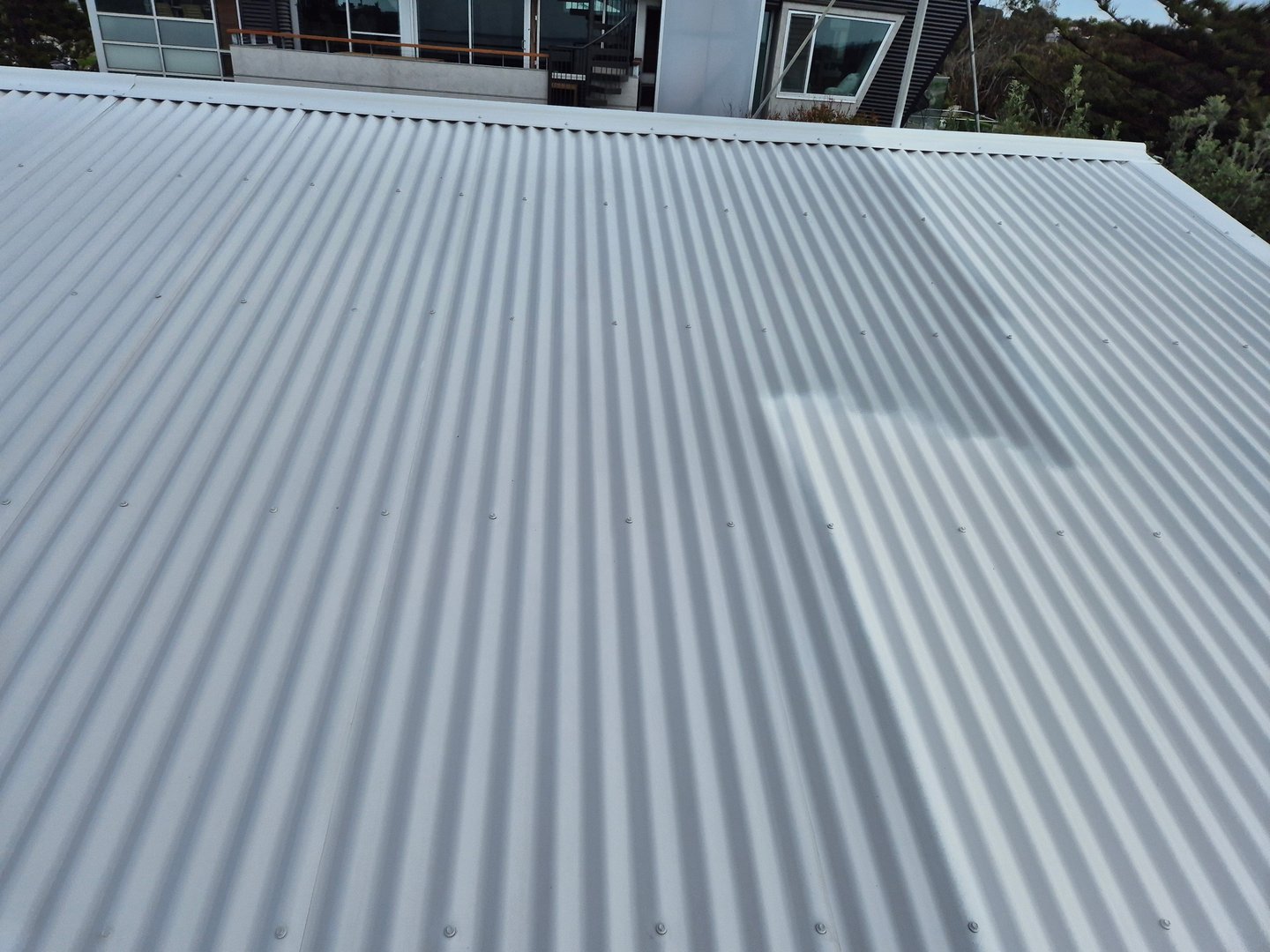 Waterproofing protection application on metal roof by Quality Painting Group