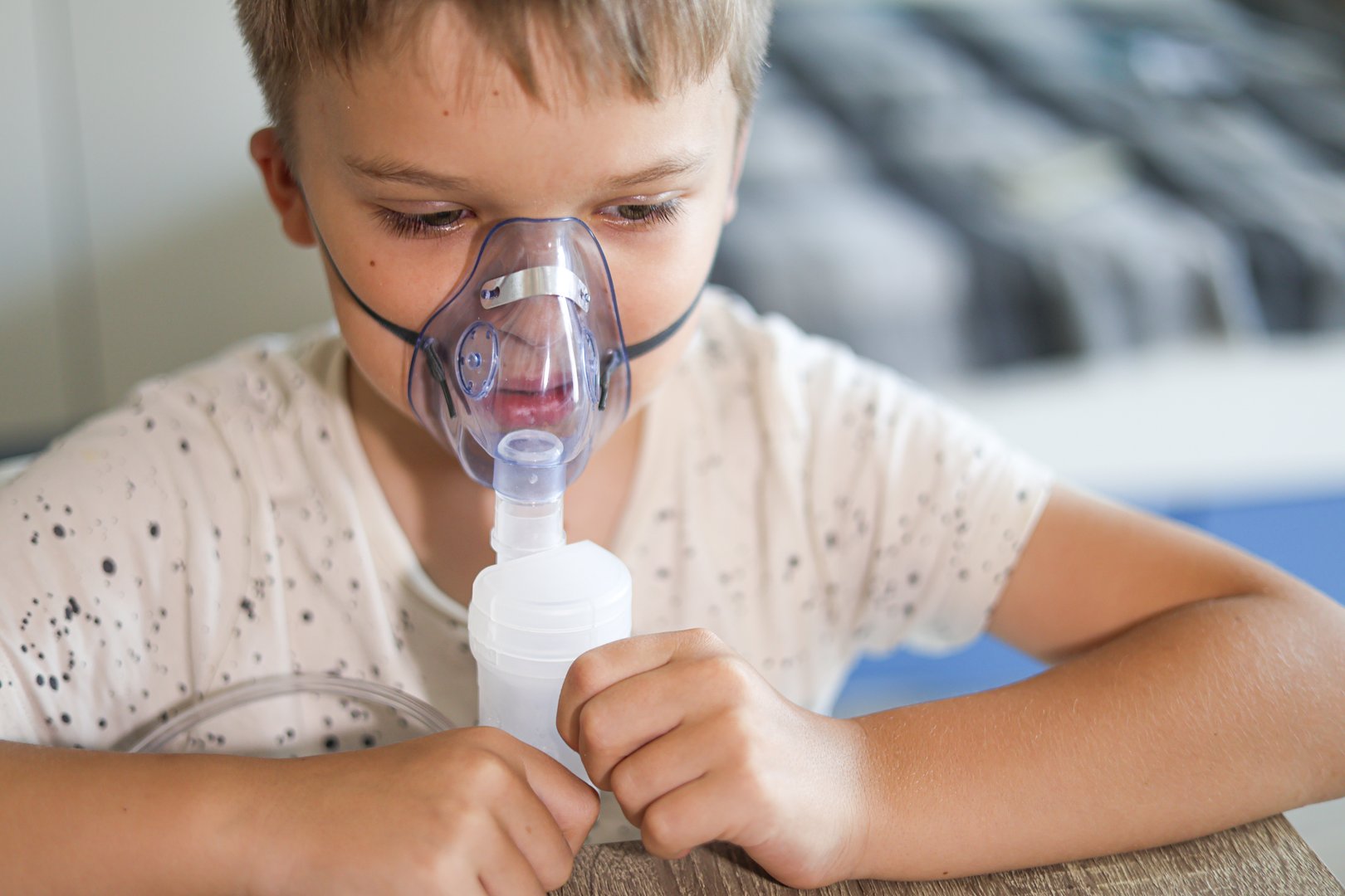 Young boy receiving nebulizer treatment during an asthma attack