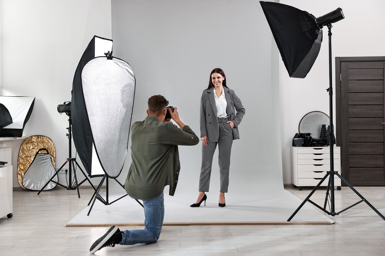 Photographer working with model in professional photo studio