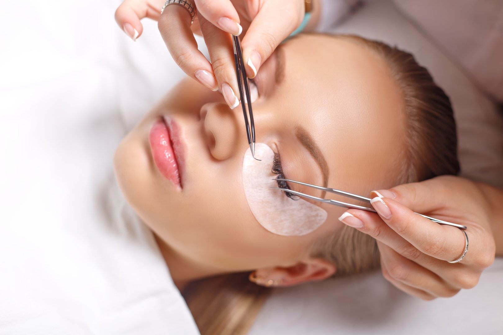 Eyelash Extension Procedure. Woman Eye with Long Eyelashes. Lashes. Close up, selected focus.