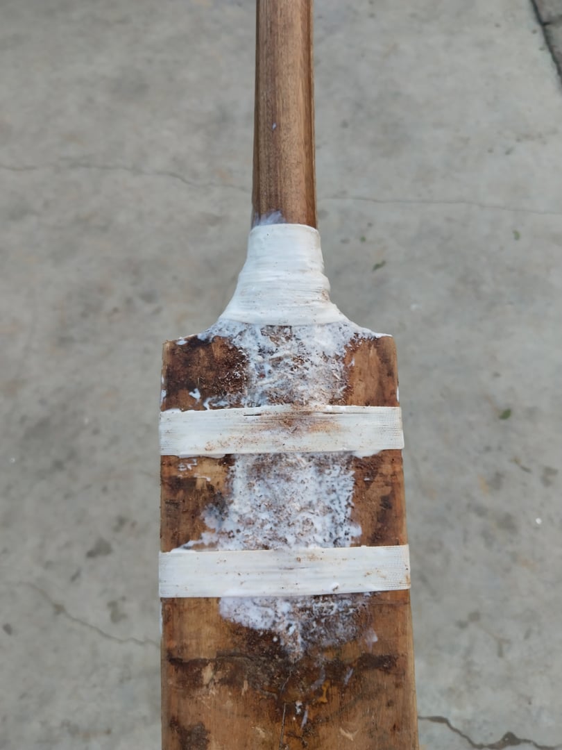 closeup of a old  broken cricket bat preparing by heavy thread and gum