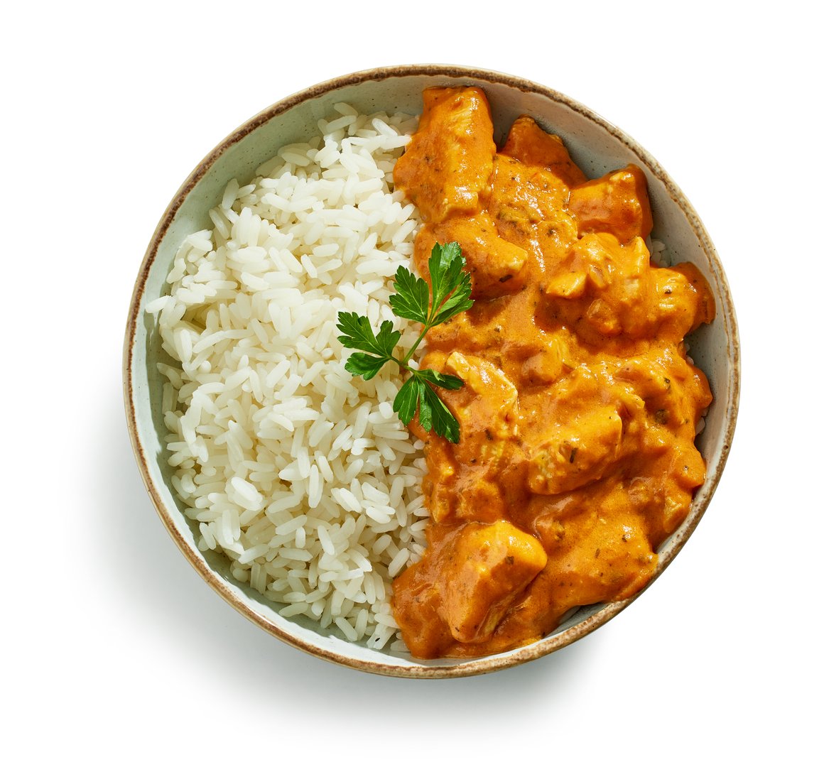 bowl of Chicken Tikka Masala with Rice isolated on white background, top view