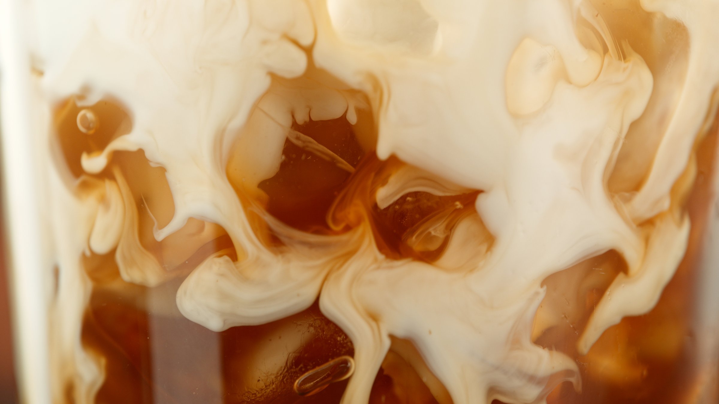 Pouring milk into coffee