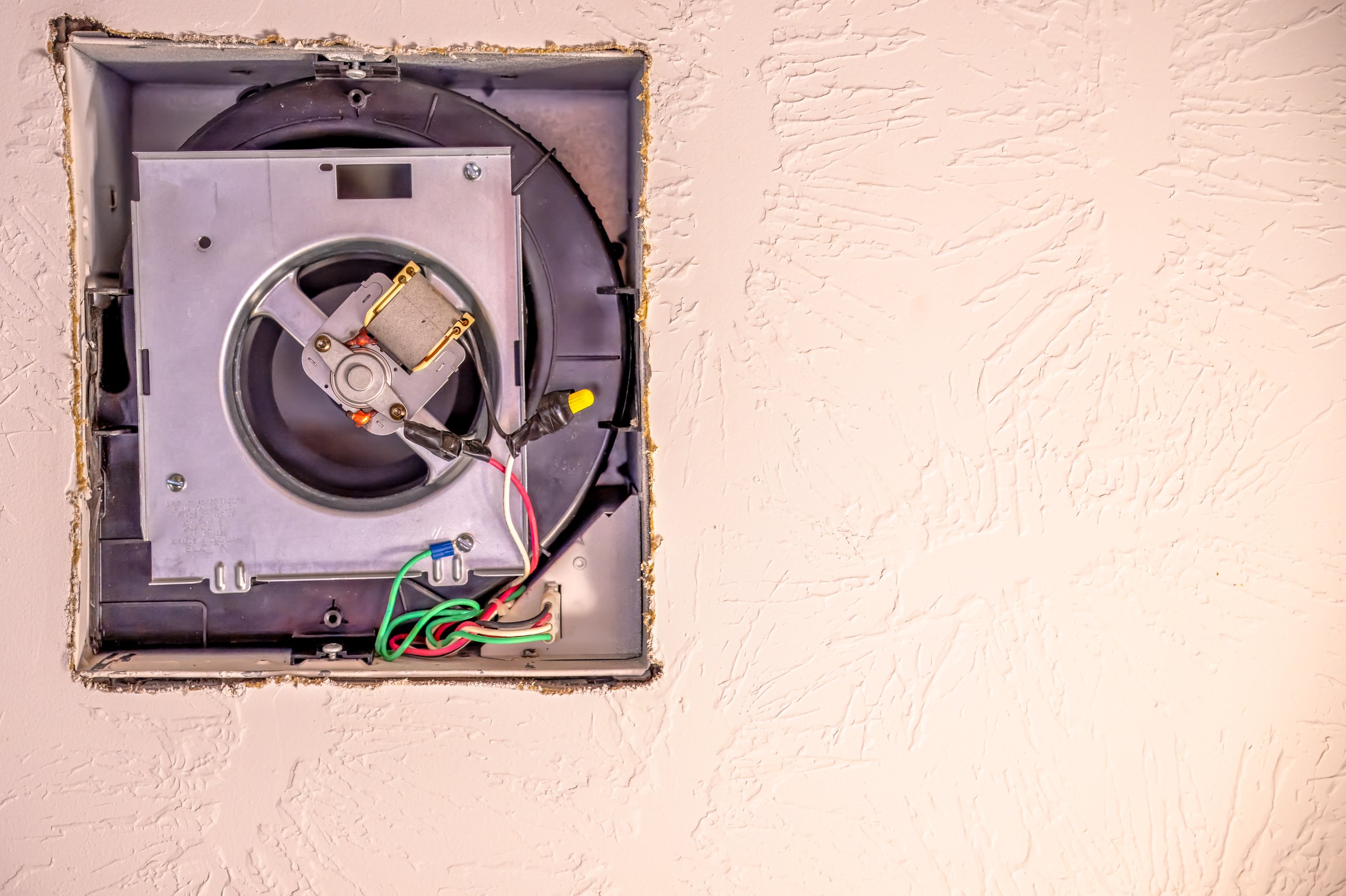 Open cover of a ceiling fan in a bathroom in order to replace a broken unit. High quality photo