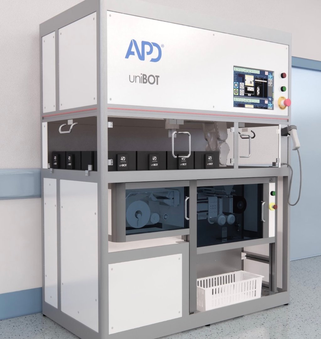 A large industrial machine labeled "UniBOT" with control panel, storage compartments, and accessible doors in a clean setting.
