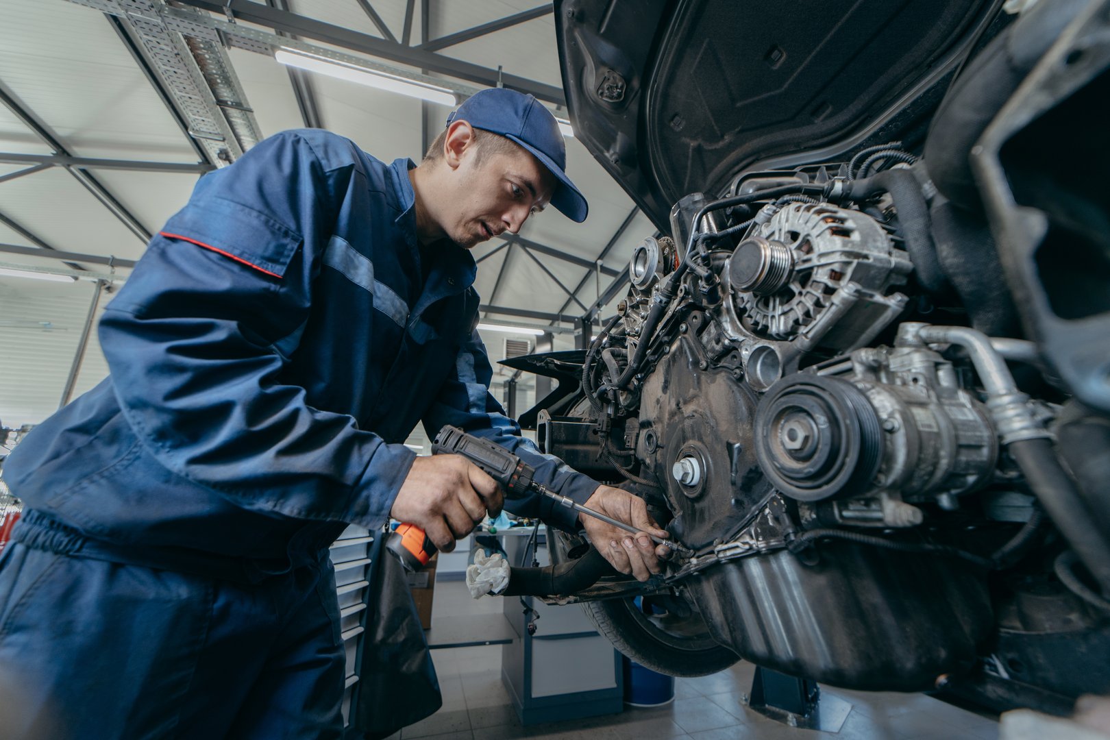 Auto mechanic repairs an engine. Replacing the timing chain