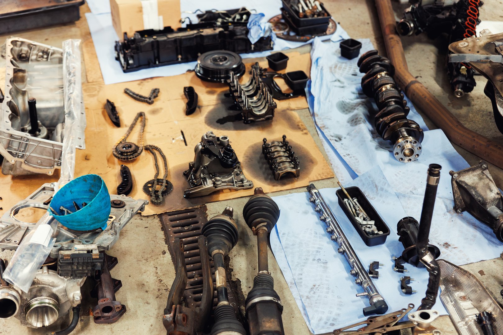 Disassembled engine components spread across workshop floor