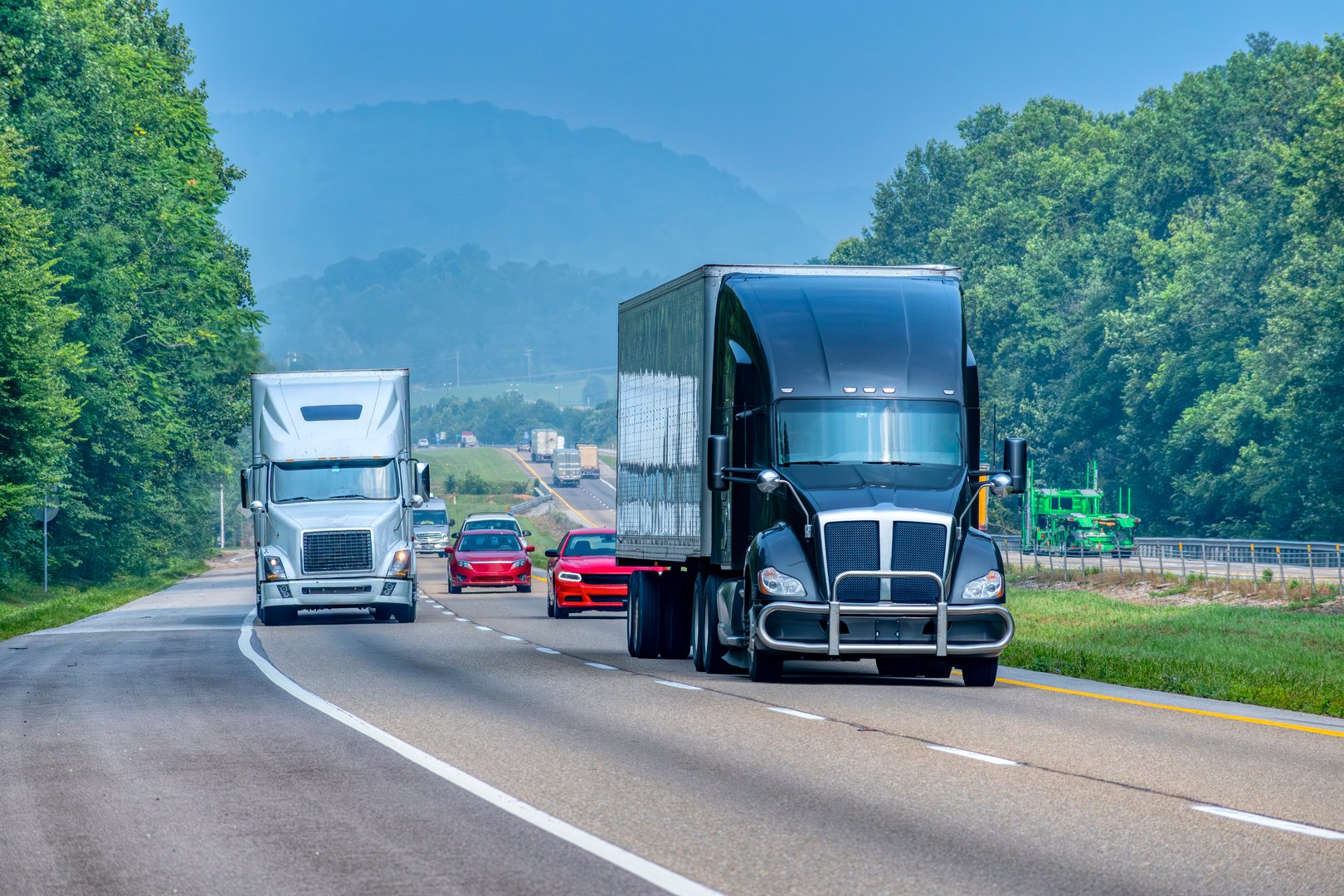 Horizontal shot of mixed traffic on a rural section of a Tennessee interstate highway.