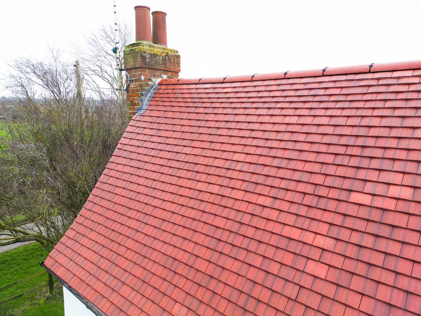 Brand new roof and tiles seen on an old English farmhouse in the UK. The original roof of the Grade 2 listed house was beyond repair.