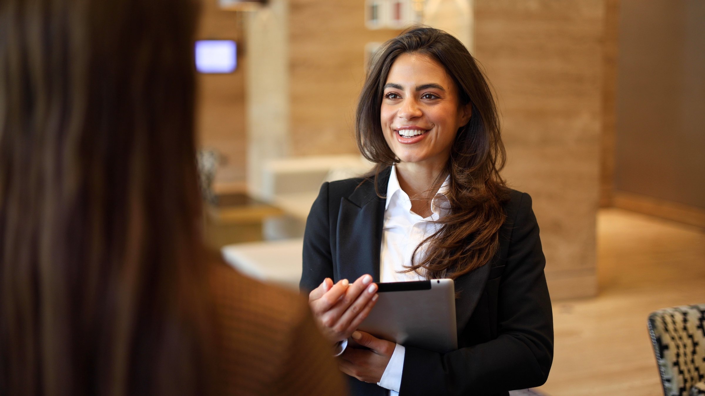 Beautiful businesswoman discussing some plans with a new business partner