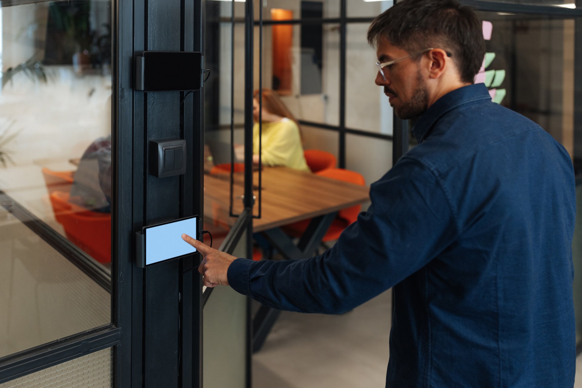 Businessman using electronic control panel for office access with blank screen, perfect for your design