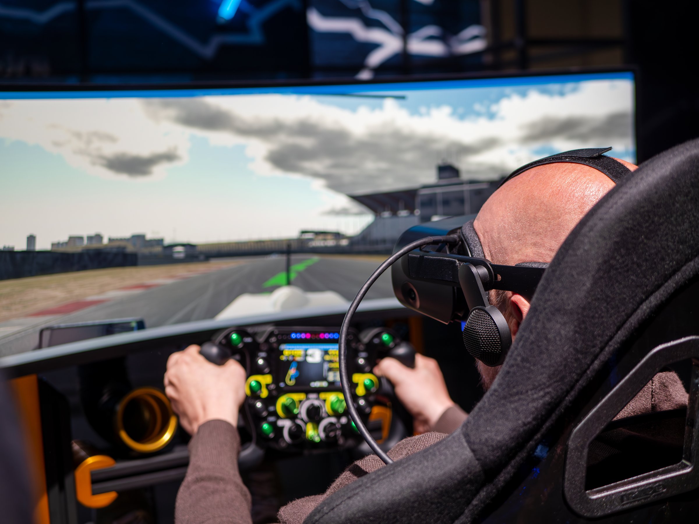 COLOGNE - AUG 26, 2023: Attendee Engages in VR Car Race Simulation at Booth