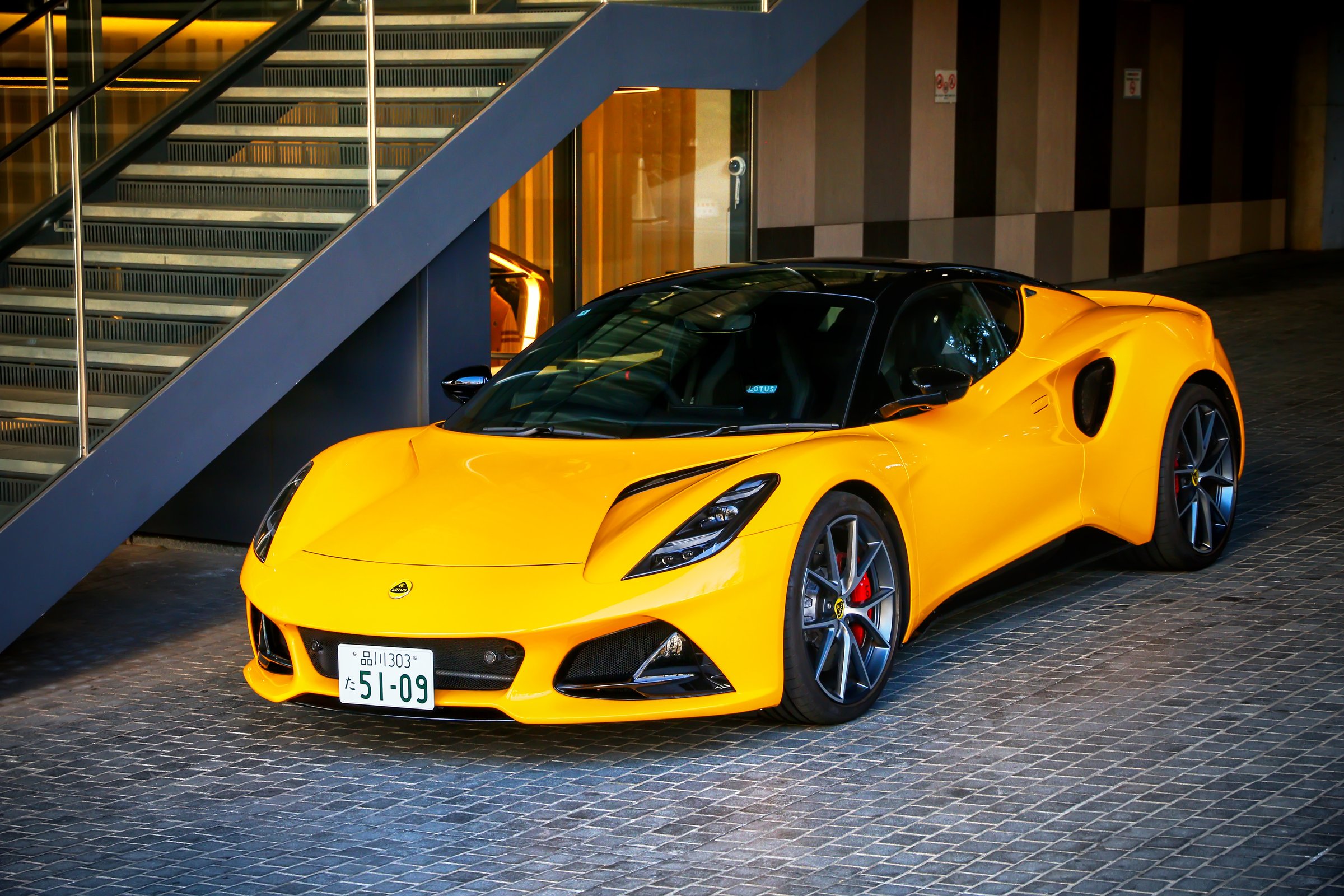 Tokyo, Japan - January 14, 2025: Yellow sports car Lotus Emira (Type 131) in the city street.