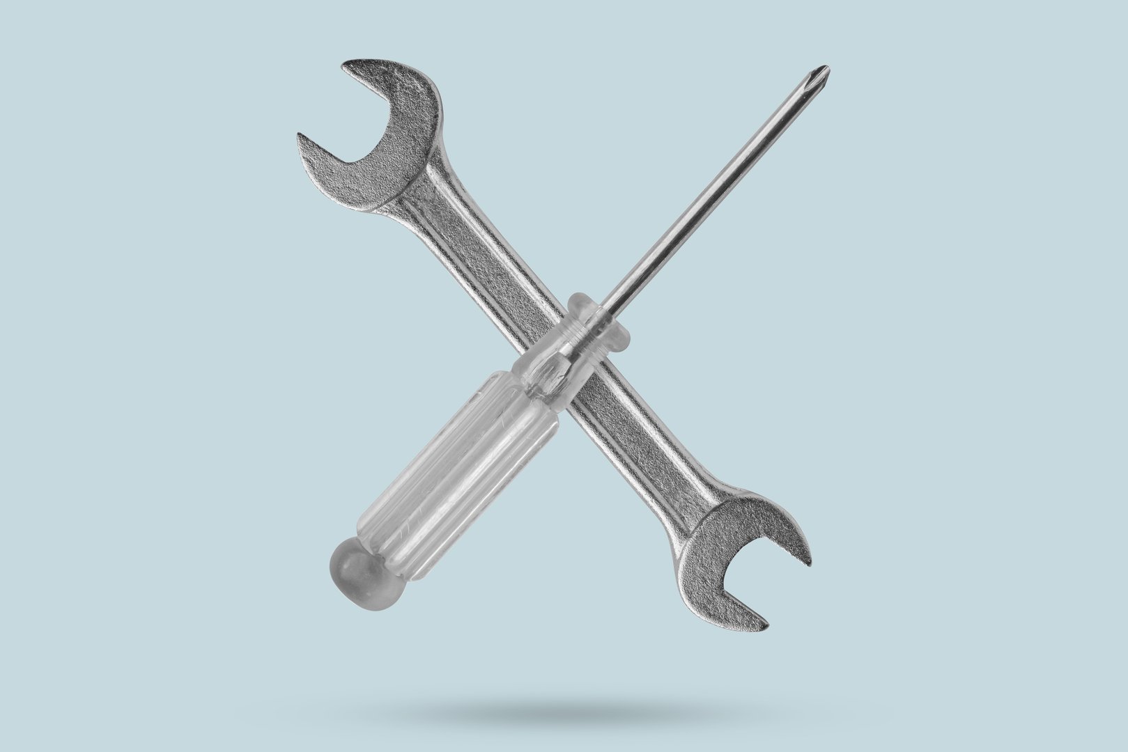 screwdriver and wrench fly on blue background close up