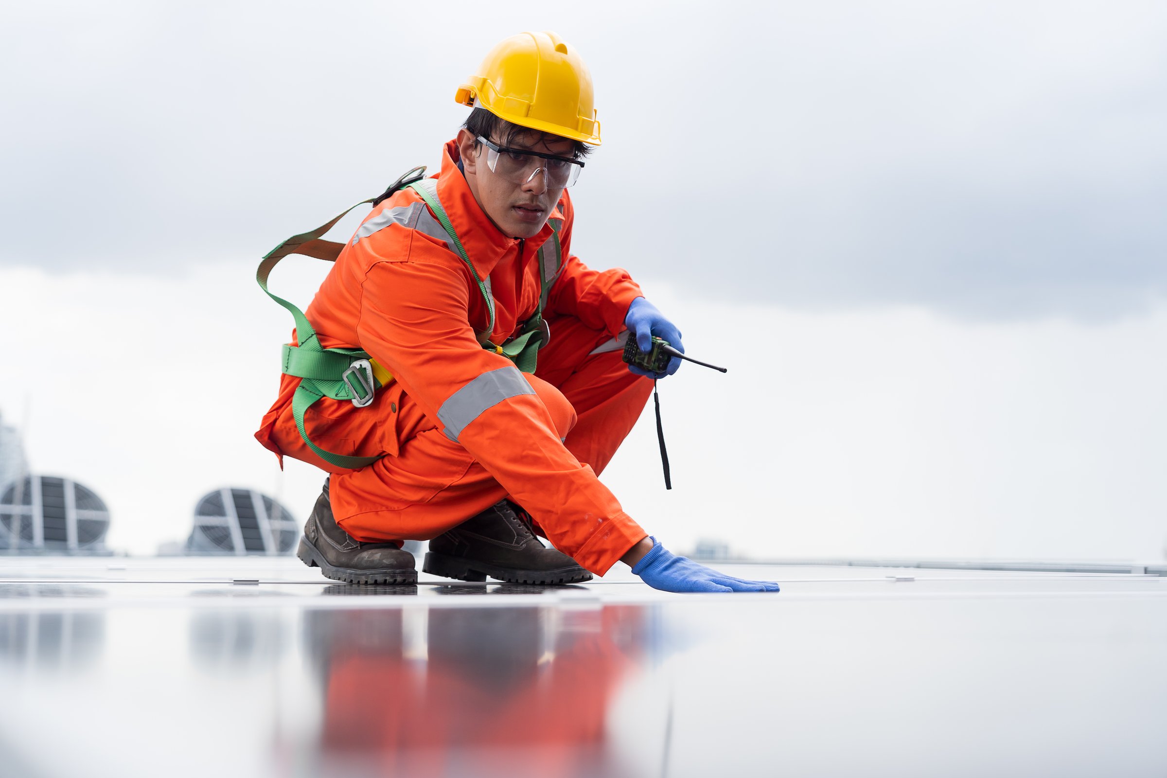 Solar panel rooftop, Rooftop solar power. Engineer or technician inspecting installation quality of solar power systems on rooftop of building. Male engineer checks solar panel on rooftop
