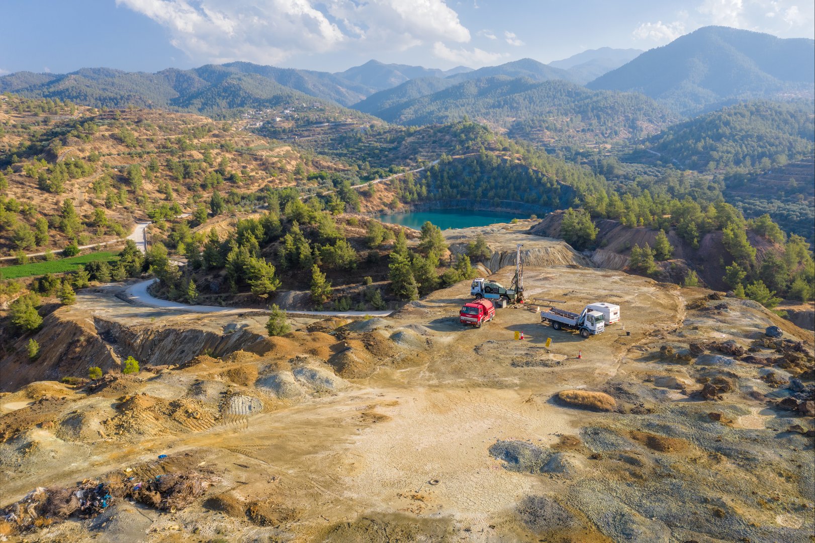 Geological exploration of abandoned copper mine. Drilling machinery on top of spoil heaps of Xyliatos mining area, Cyprus