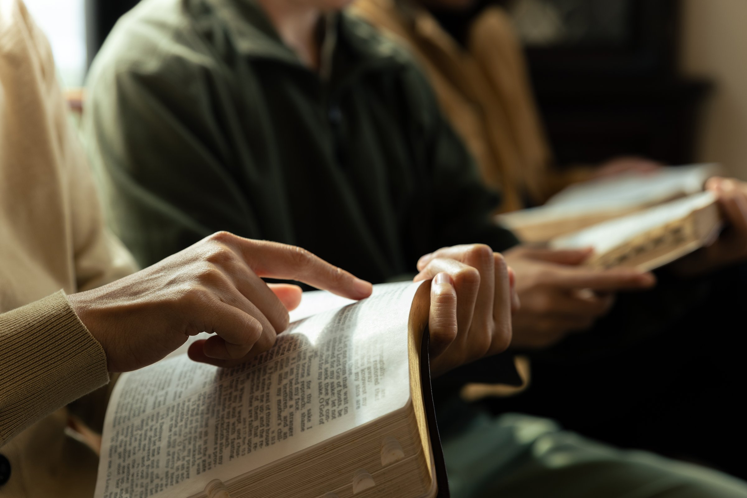 Christian group are praying to god with the bible and sharing the gospel, Believe in goodness, Spirituality and religion concept.