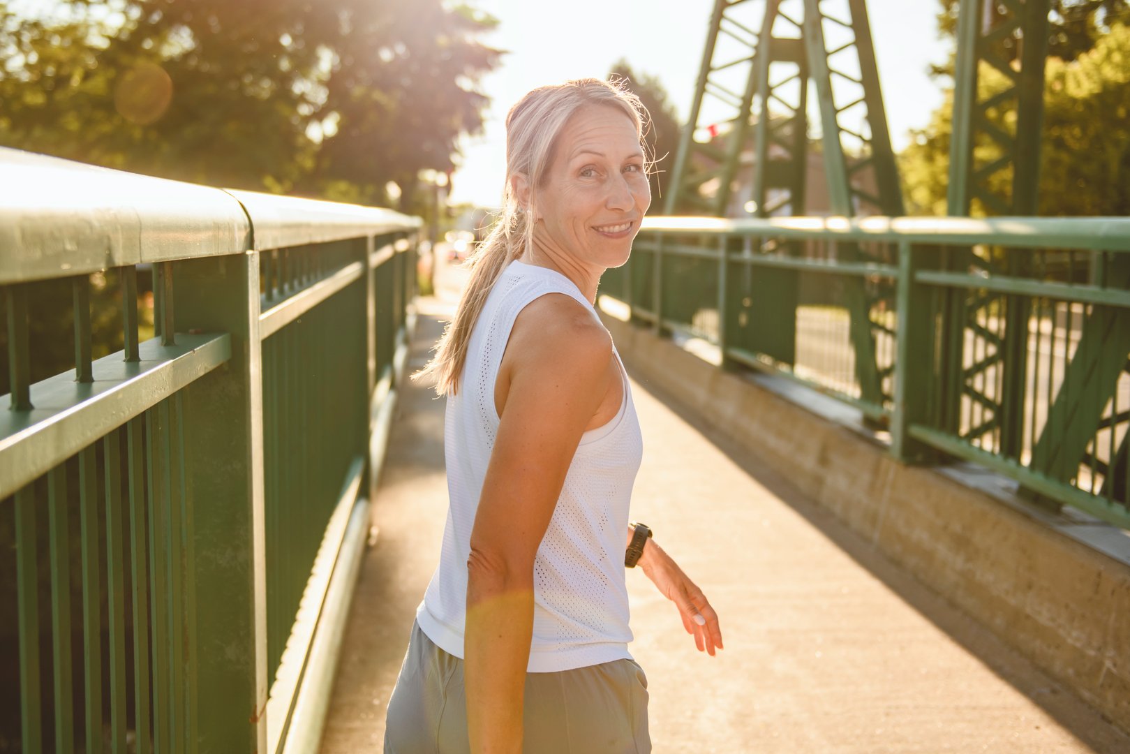 A great sporty woman jogging outdoors on sunset time