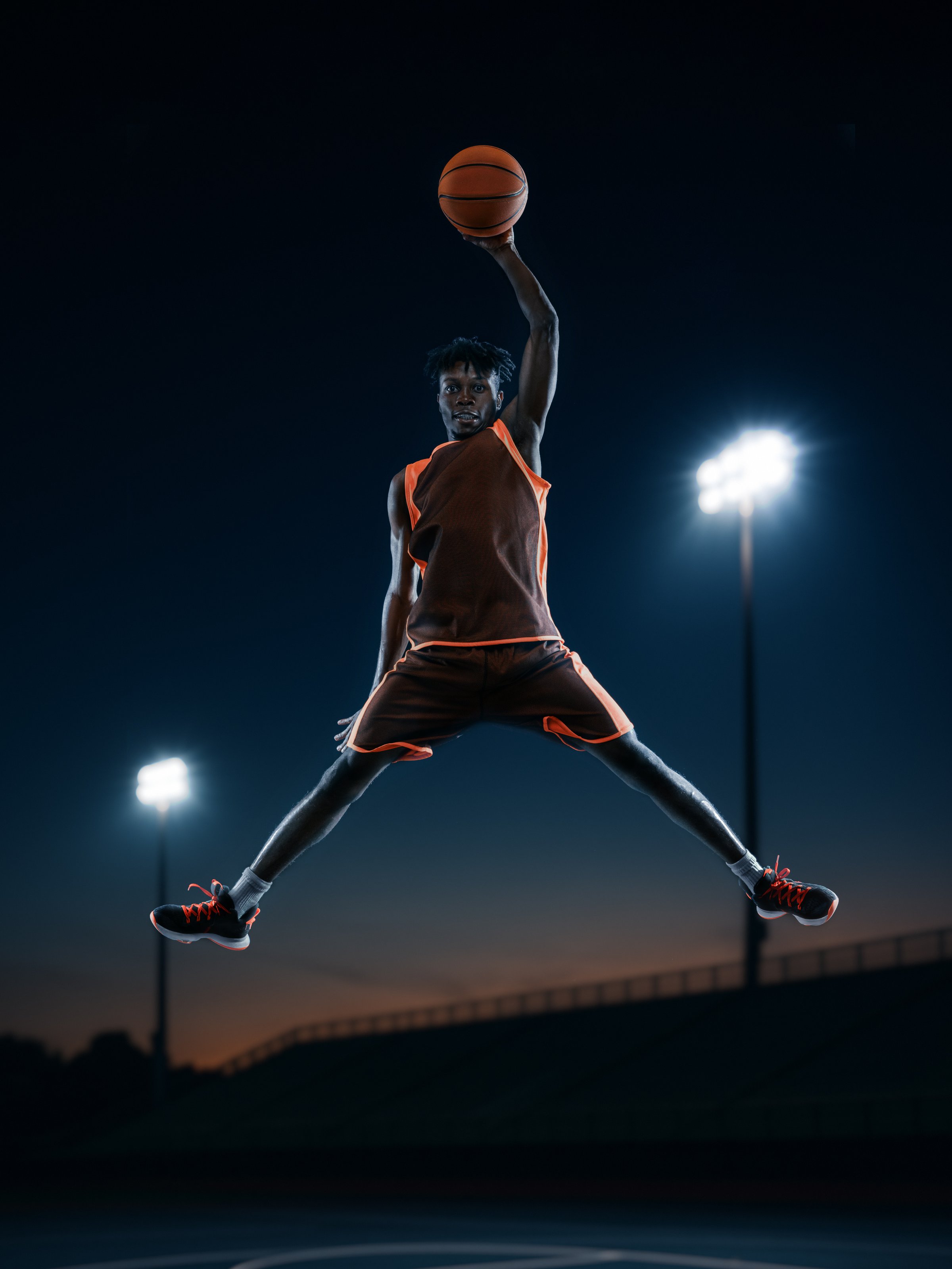 Creative graphic artwork. Confident basketball player celebrating mid-air dunk under arena lights. Concept of sports celebration, motivation visuals, fitness promotion, and emotional team branding.