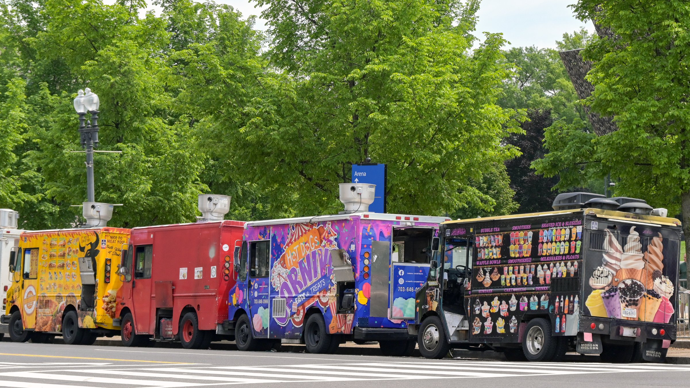 Washington DC, USA - 30 April 2024: Row of fast food and ice cream trucks parked on one of the main roads in Washington DC