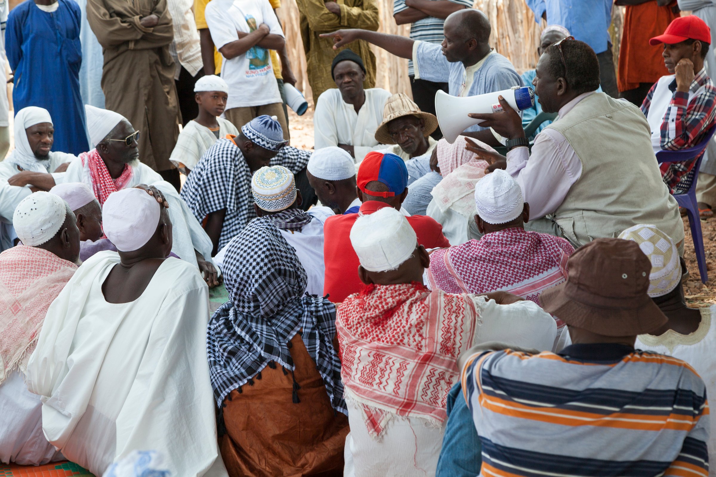 Gabu, Guinea-Bissau - May 9, 2014: village council meeting in rural africa with activists speaking to elders