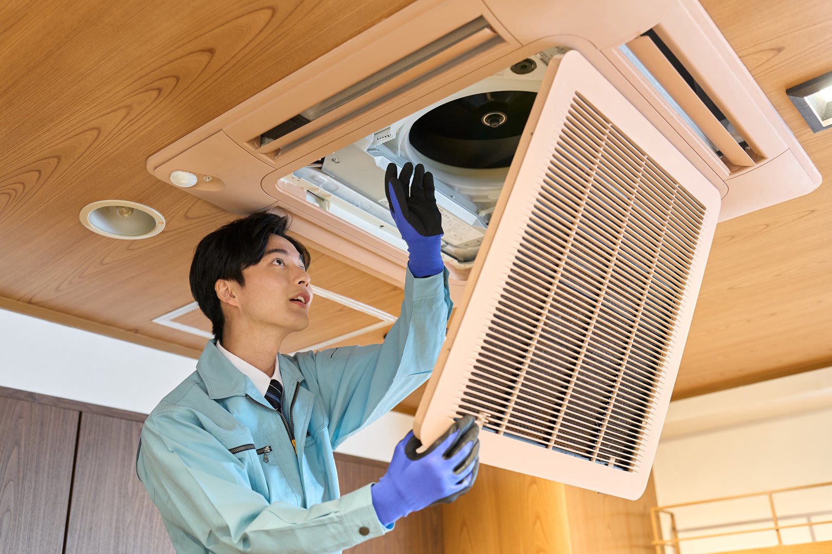A man checking the air conditioning equipment in a restaurant
