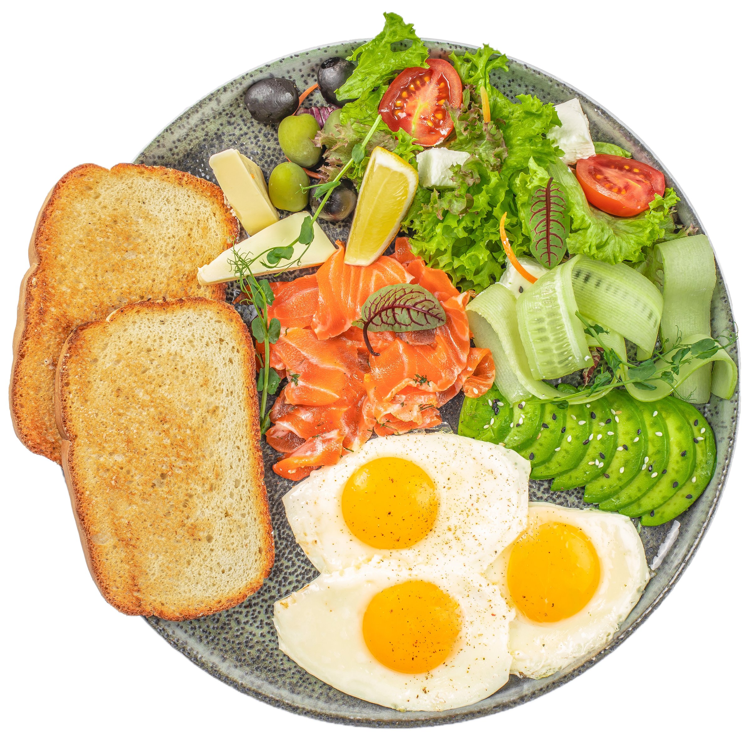 Plate of breakfast with salmon, sunny side eggs, avocado and vegetable salad isolated on white background. top view.
