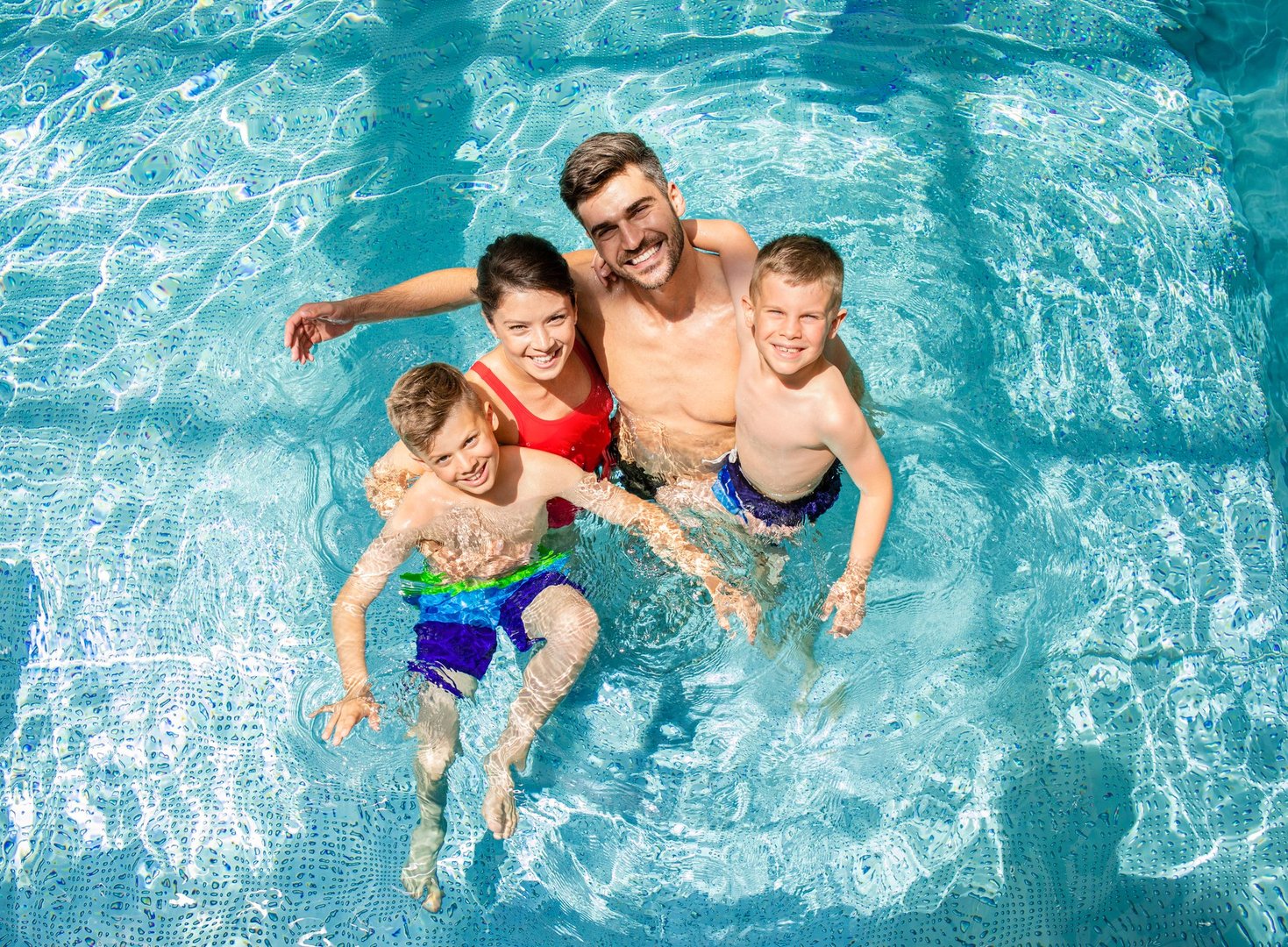 Happy people enjoying themselves by the pool