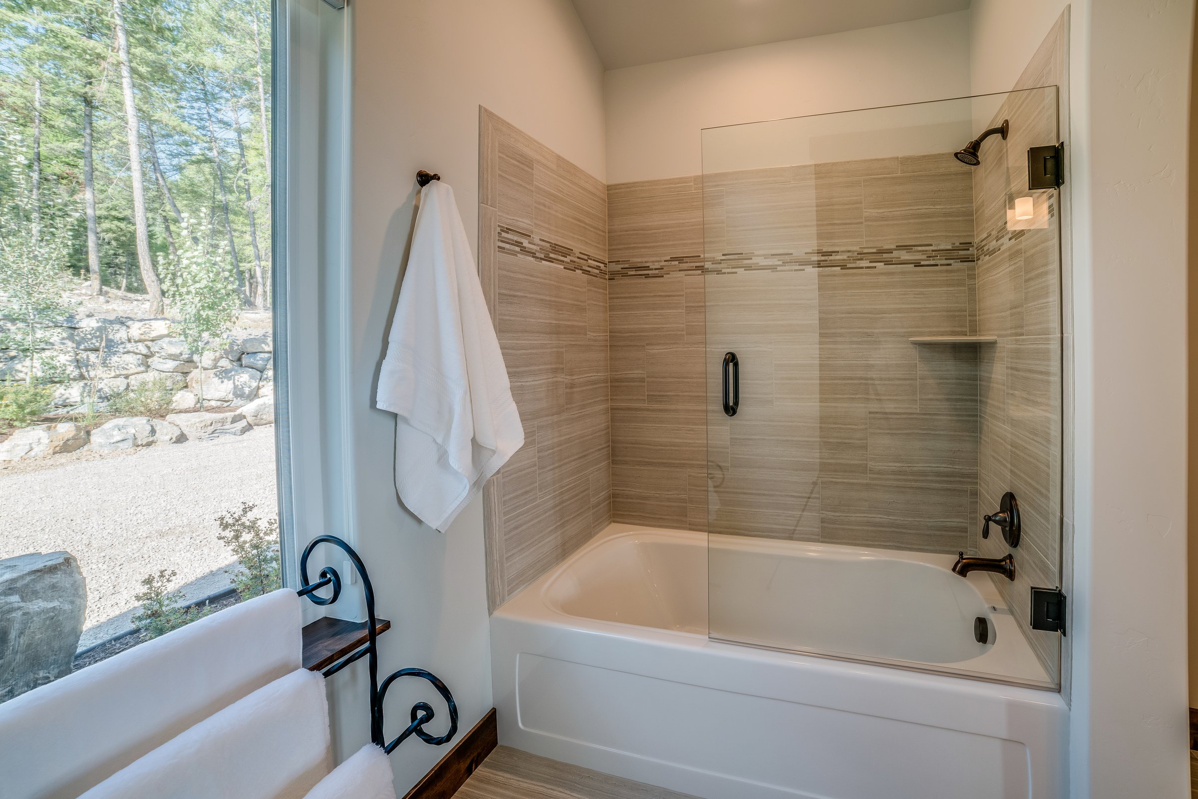 Bright bathroom with white towels and large window