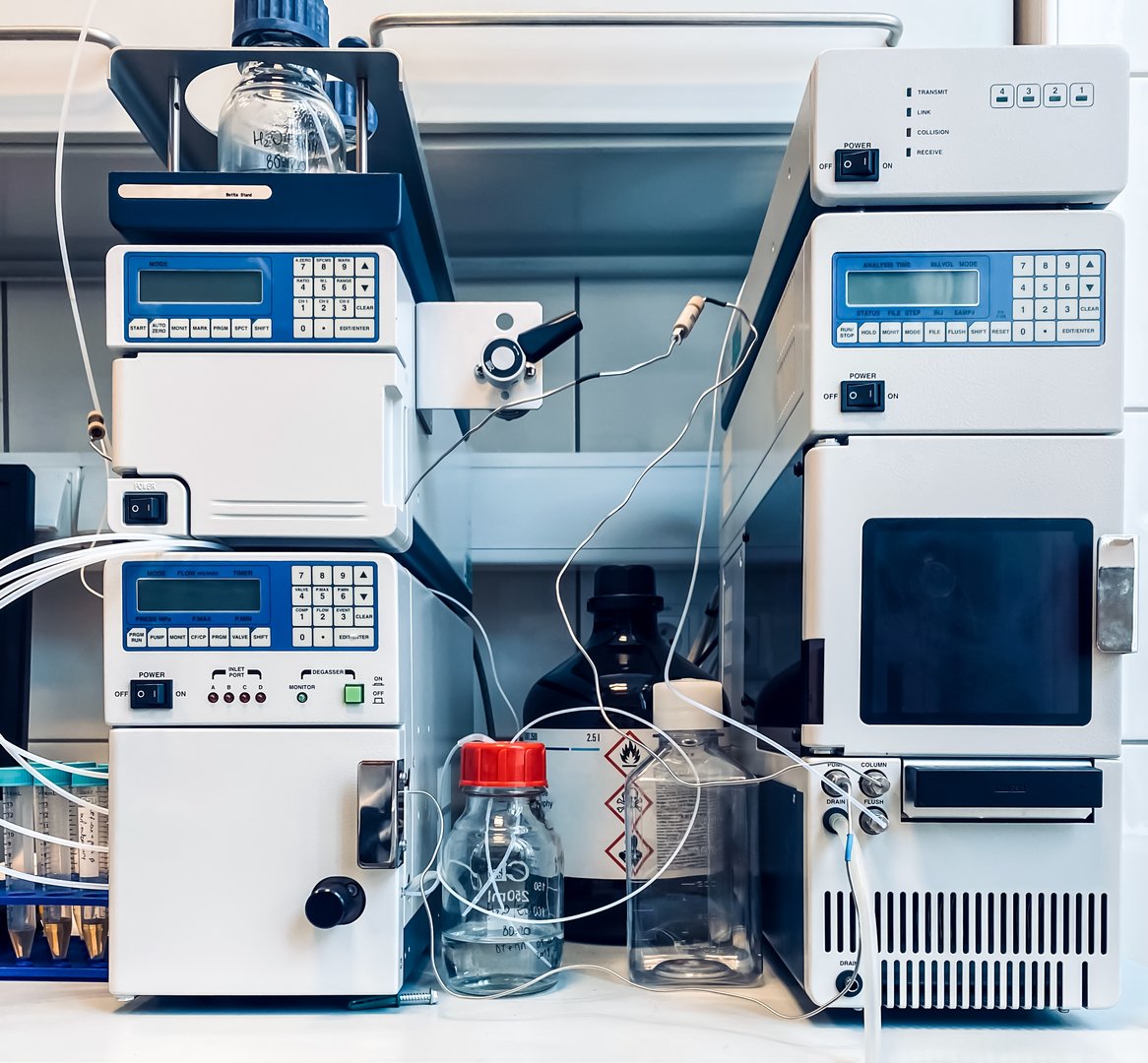 A high-performance liquid chromatography setup; including a pumping device generating a gradient of two different solvents, an autosampler, and a detector for measuring the absorbance.