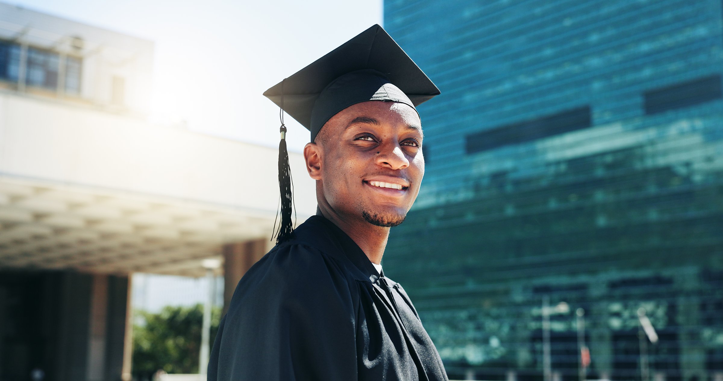City, graduation and thinking with black man student outdoor for celebration or education event