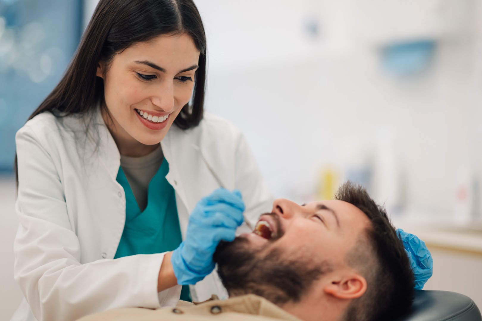 Dentist examining patient teeth in modern clinic