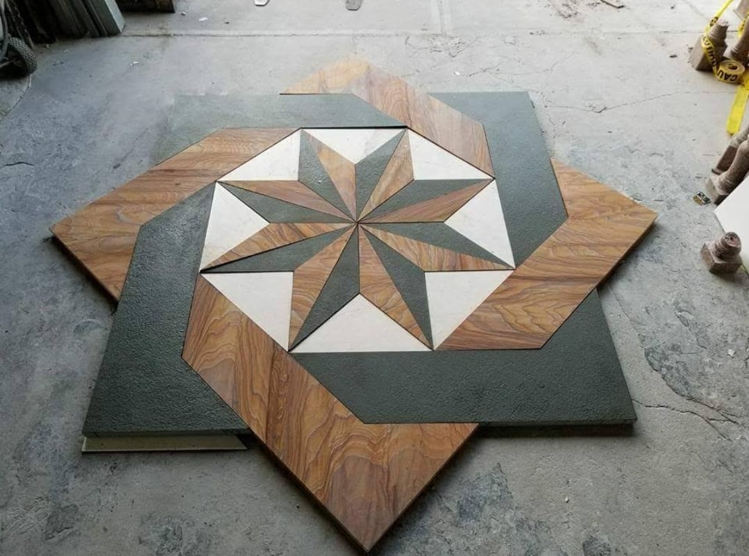 Construction worker using pneumatic nailer and safety helmet applying roofing materials against blue sky backdrop