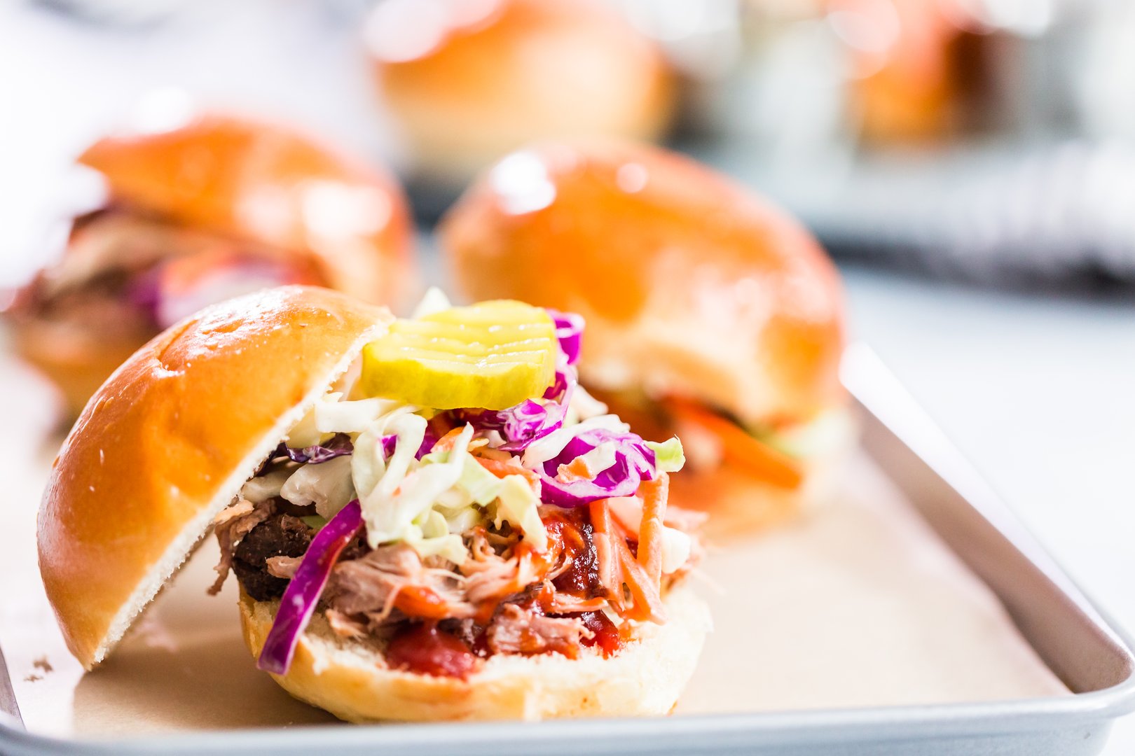 BBQ pulled pork sandwich in shape of small sliders with brioche buns.